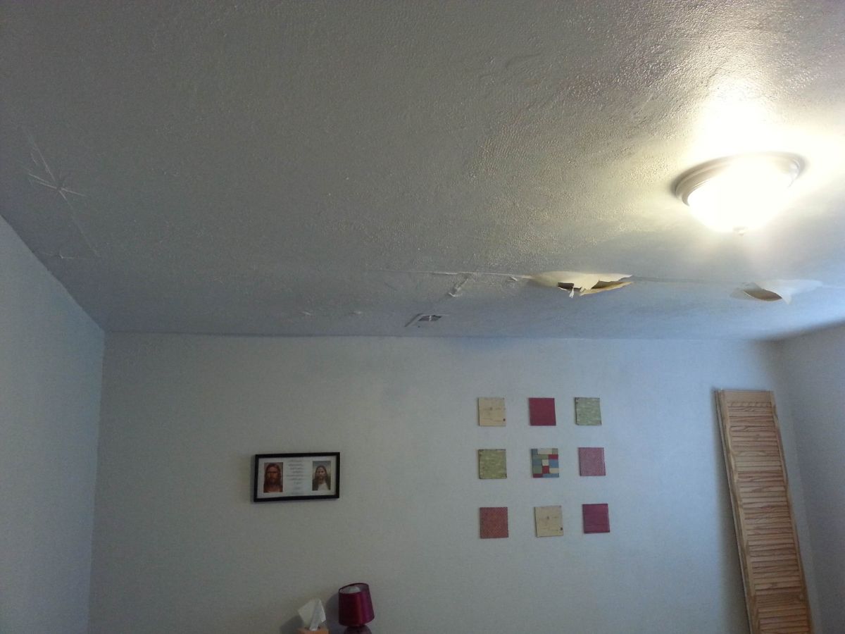 Water damage on the ceiling of the bedroom